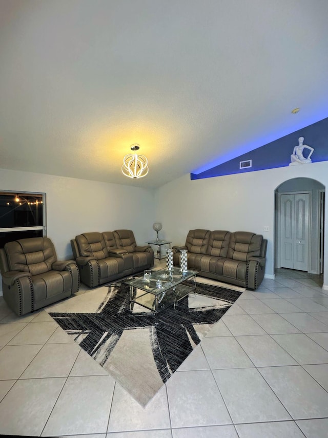 tiled living room with vaulted ceiling