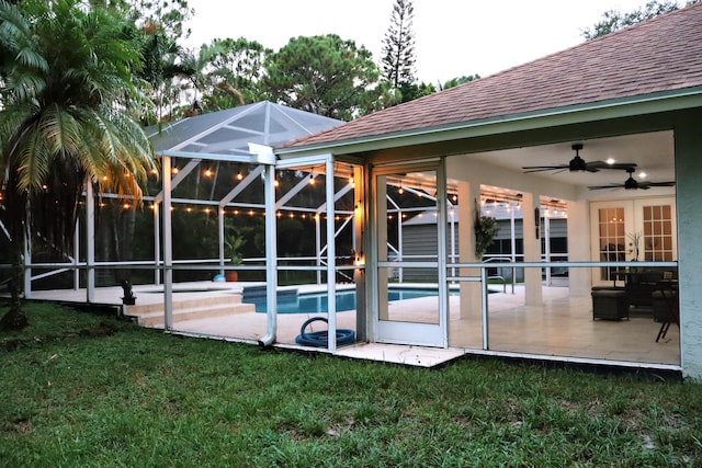 rear view of house featuring a lawn, ceiling fan, and a patio