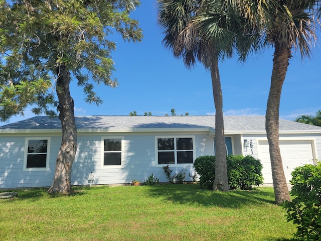 view of front facade featuring a garage and a front lawn