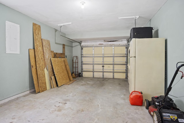 garage with white refrigerator and electric panel