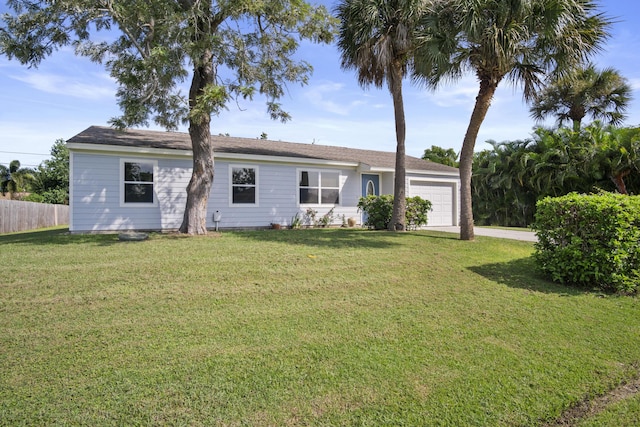 ranch-style home with a front yard and a garage