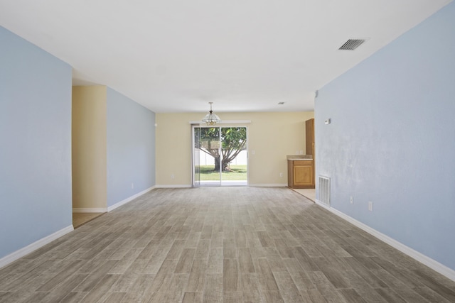 unfurnished room with light hardwood / wood-style flooring