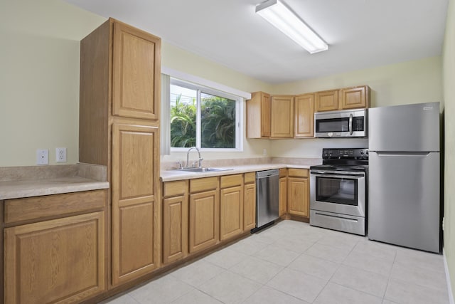 kitchen featuring appliances with stainless steel finishes, light tile patterned floors, and sink