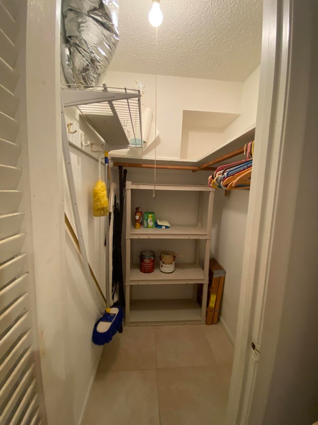 walk in closet featuring light tile patterned flooring