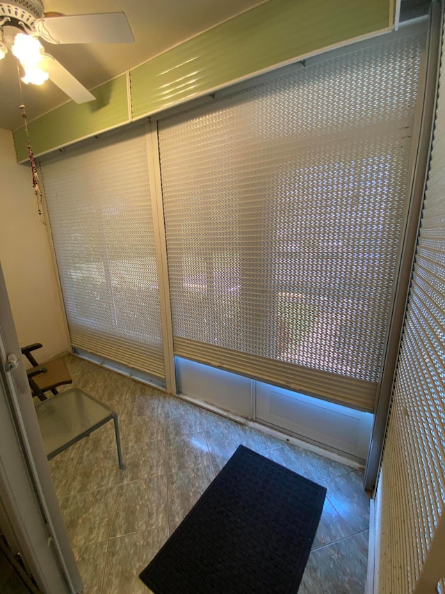 bathroom with ceiling fan and tile patterned floors