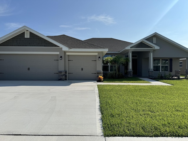 craftsman inspired home with roof with shingles, stucco siding, concrete driveway, an attached garage, and a front lawn