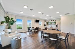 dining space with dark hardwood / wood-style flooring and ornamental molding