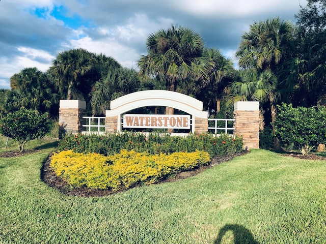 community / neighborhood sign with a lawn