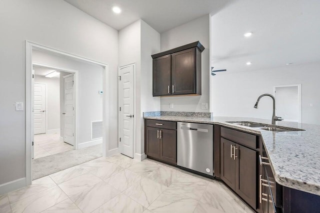 kitchen featuring dark brown cabinetry, light stone countertops, sink, ceiling fan, and stainless steel dishwasher