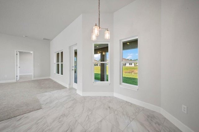 spare room with light carpet and vaulted ceiling