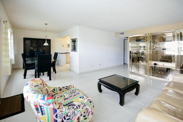 tiled living room with a textured ceiling