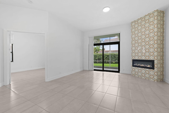 unfurnished living room featuring light tile patterned floors and a tiled fireplace