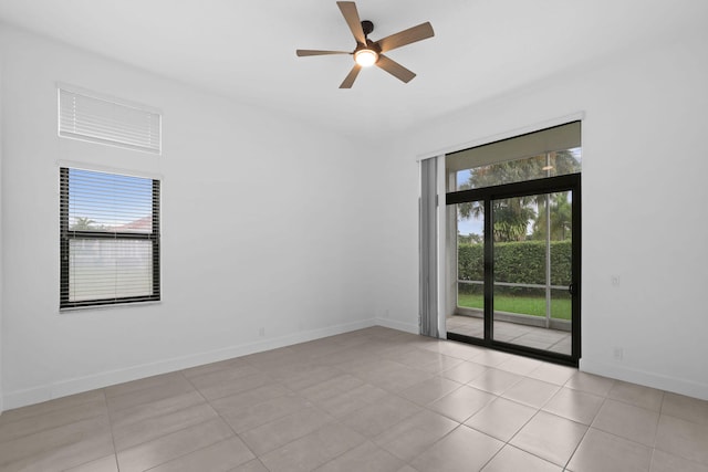 empty room featuring ceiling fan and light tile patterned flooring