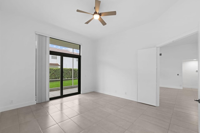 unfurnished room with tile patterned flooring, baseboards, and a ceiling fan