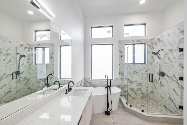 bathroom with tile patterned flooring, separate shower and tub, and vanity