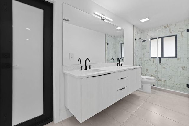 bathroom with an enclosed shower, toilet, dual bowl vanity, and tile patterned floors