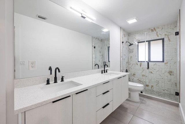 full bathroom with a marble finish shower, visible vents, a sink, and toilet