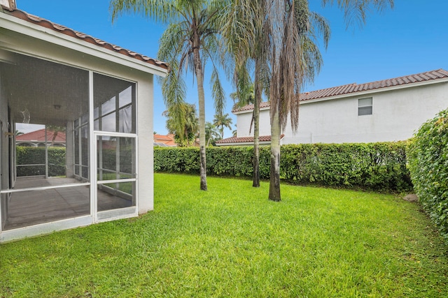 view of yard featuring a sunroom