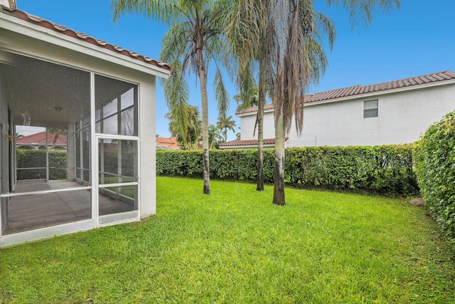 view of yard with a sunroom