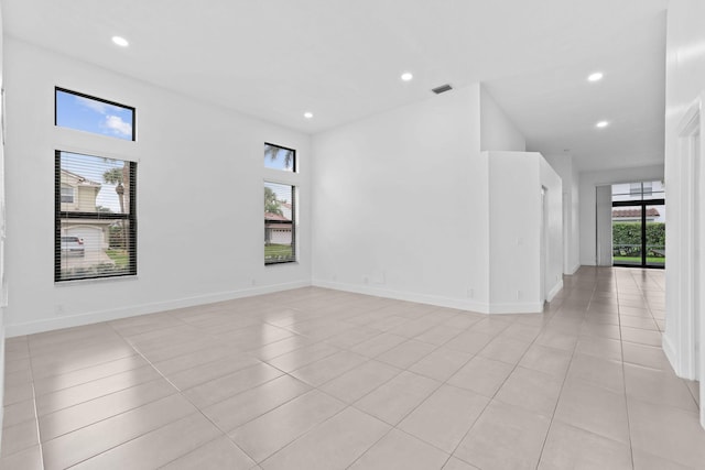 empty room featuring light tile patterned flooring, recessed lighting, visible vents, and baseboards