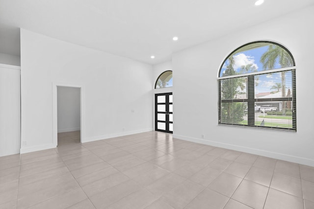 empty room featuring baseboards, recessed lighting, and a healthy amount of sunlight