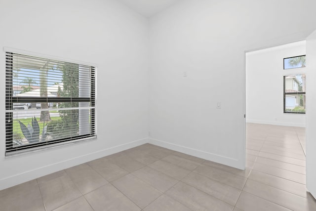 tiled empty room featuring a wealth of natural light