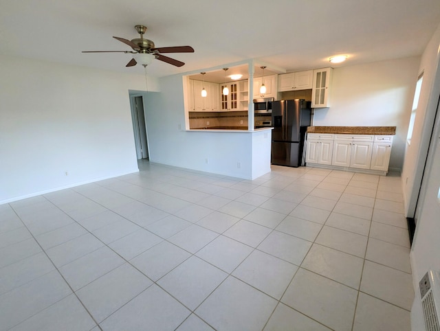 kitchen featuring kitchen peninsula, light tile patterned floors, white cabinetry, and fridge with ice dispenser