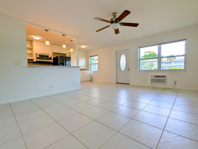 entrance foyer with an AC wall unit, ceiling fan, and light tile patterned floors