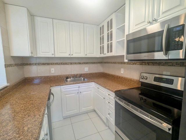 kitchen featuring decorative backsplash, sink, white cabinetry, and stainless steel appliances