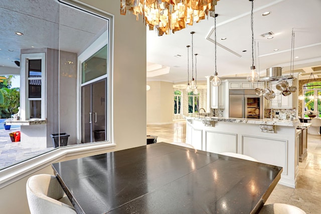 unfurnished dining area featuring light tile patterned floors and a chandelier