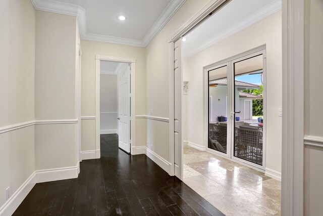 hallway with ornamental molding and wood-type flooring