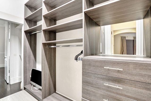 walk in closet featuring dark wood-type flooring