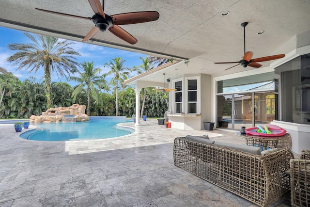 view of swimming pool featuring ceiling fan and a patio