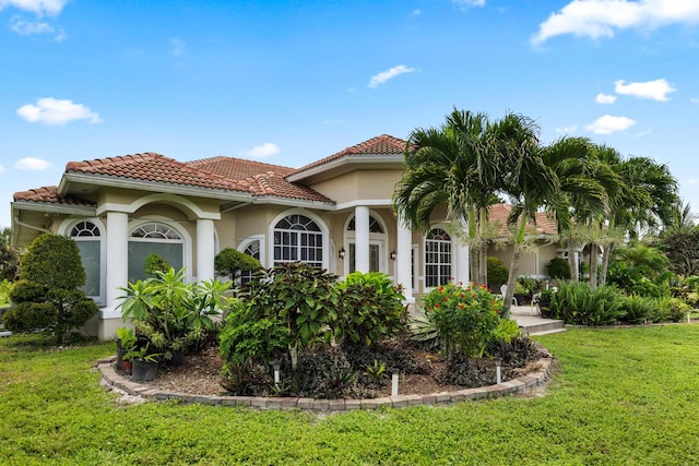 mediterranean / spanish-style home with a front lawn