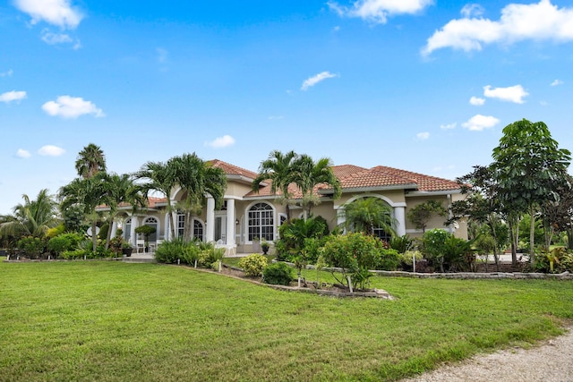 mediterranean / spanish-style house with a front yard