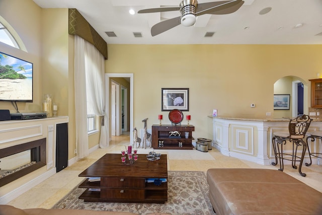 living room with ceiling fan and plenty of natural light