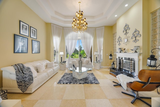 living room with an inviting chandelier and a tray ceiling