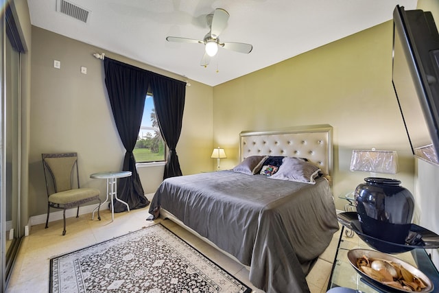 bedroom with a closet, ceiling fan, and light tile patterned floors