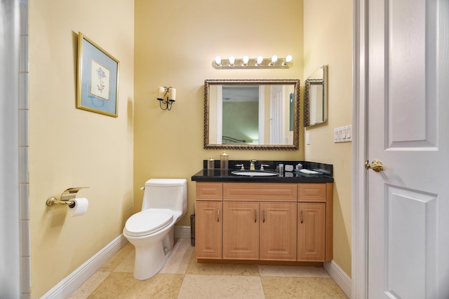 bathroom featuring tile patterned flooring, vanity, and toilet