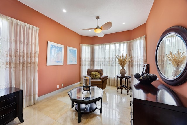 living area featuring ceiling fan