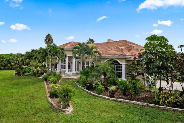 rear view of house featuring a lawn and a patio area