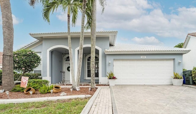 mediterranean / spanish-style home featuring a garage