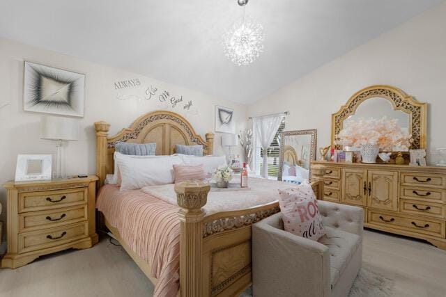 bedroom with vaulted ceiling and a chandelier