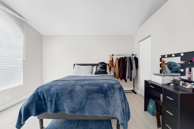 bedroom with light hardwood / wood-style flooring and vaulted ceiling