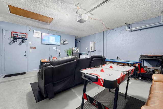 rec room featuring concrete floors and a textured ceiling