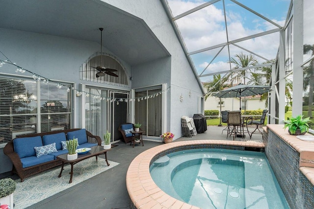 view of pool with a lanai, ceiling fan, a patio area, and an outdoor hangout area