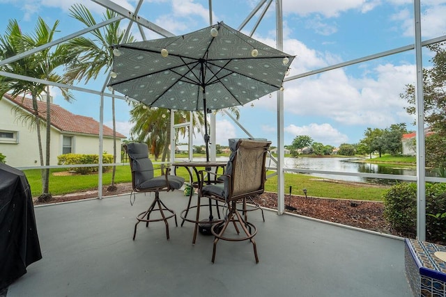 sunroom / solarium featuring a water view