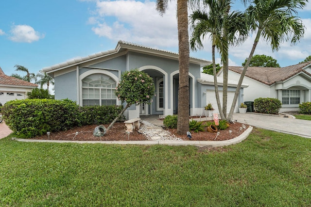 view of front of property featuring a garage and a front lawn