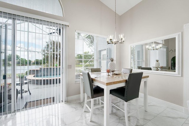 dining room featuring high vaulted ceiling and an inviting chandelier