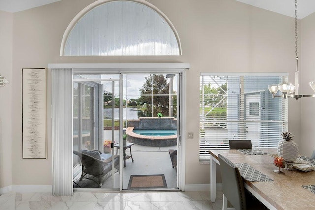 doorway with an inviting chandelier and lofted ceiling